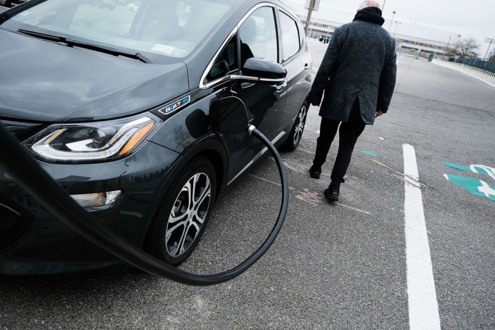 PHOTO: A driver uses a fast-charging station for electric in the cell phone lot at John F. Kennedy (JFK) airport  on April 02, 2021 in New York City.