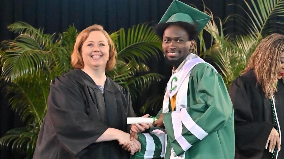 PHOTO: Elijah Hogan graduated from Walter L. Cohen High School as valedictorian. Hogan is pictured with Cohen High School Principal Rhonda Dale.