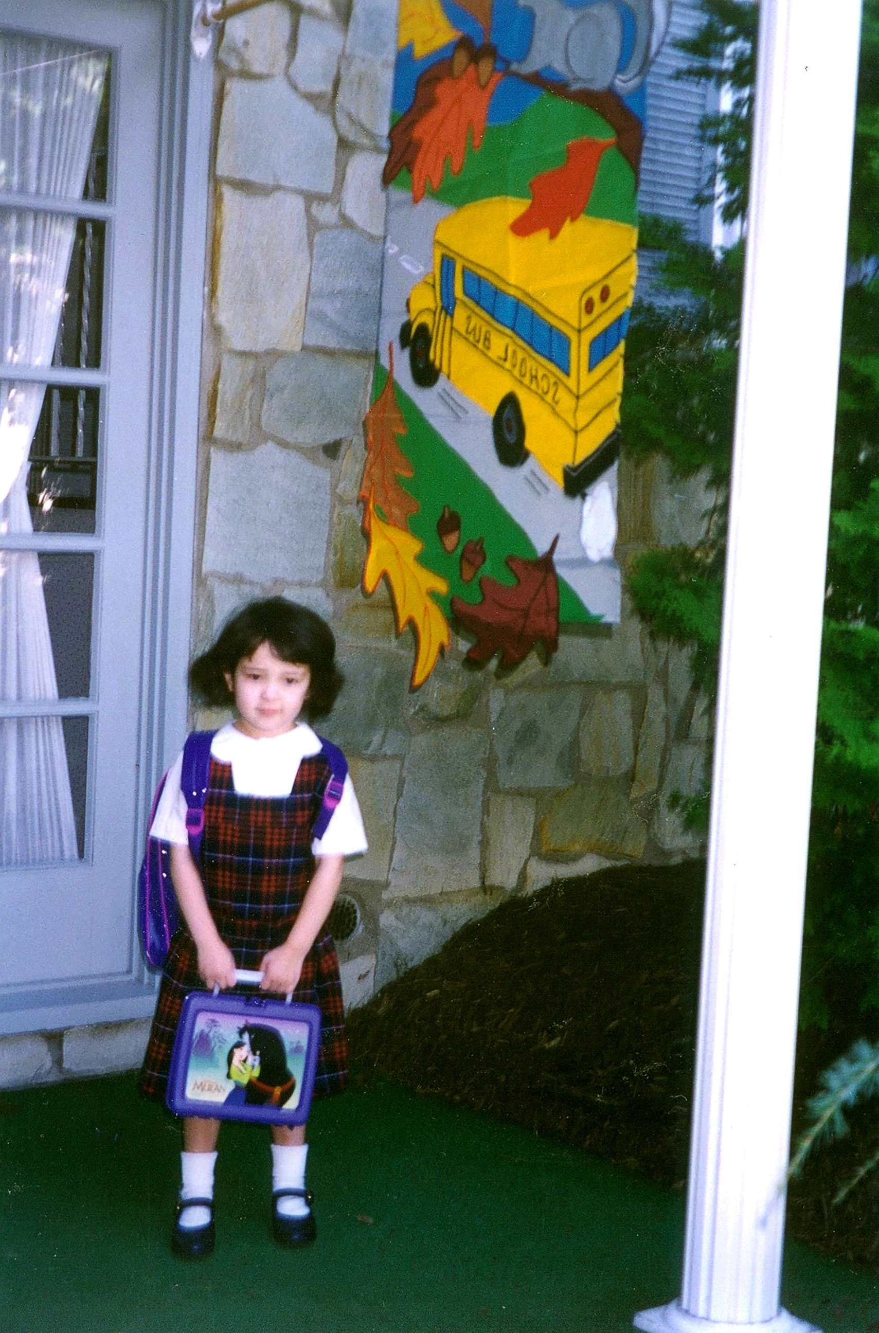 PHOTO: Standing in front of my house before heading off to Kindergarten with my "Mulan" lunchbox. 