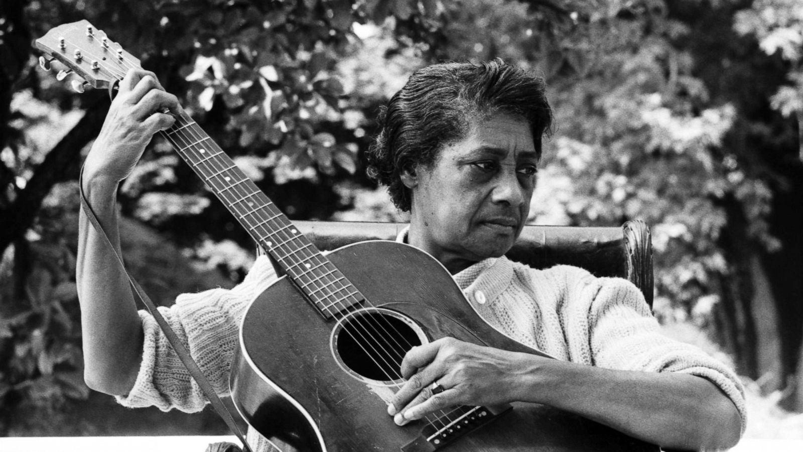 PHOTO: Folk and blues singer Elizabeth "Libba" Cotten poses for a portrait with her guitar at the Newport Folk Festival in July 1964 in Newport, R.I.