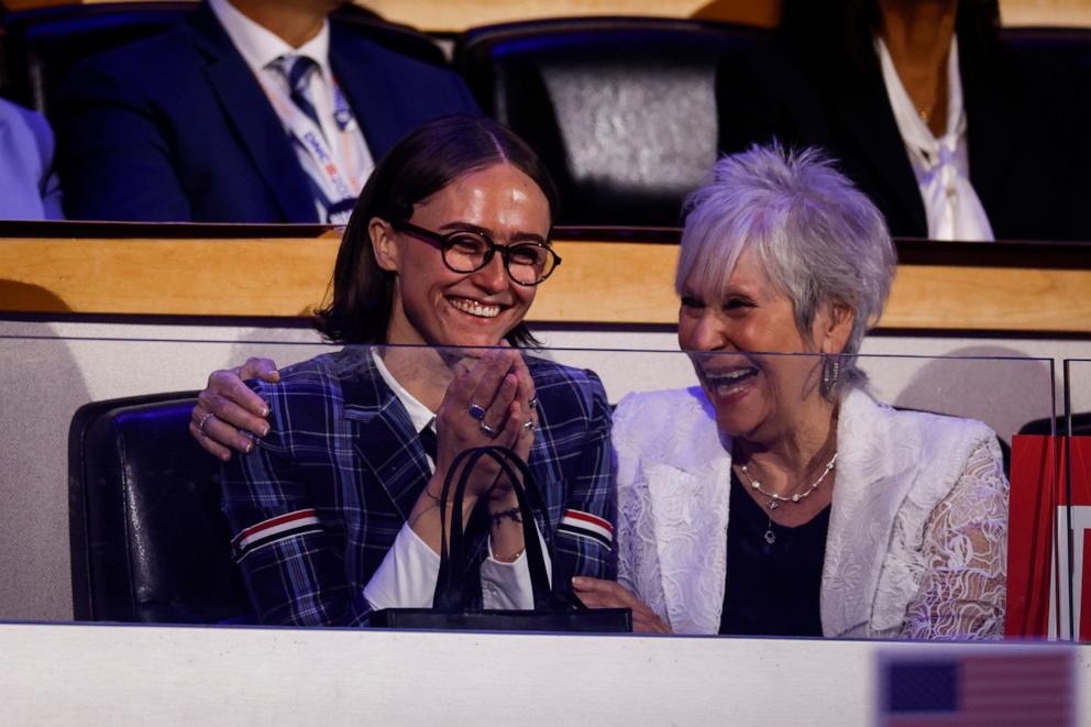 PHOTO: Ella Emhoff, left, watches her father, Doug Emhoff, deliver a speech on the second day of the Democratic National Convention at the United Center, Aug. 20, 2024, in Chicago.