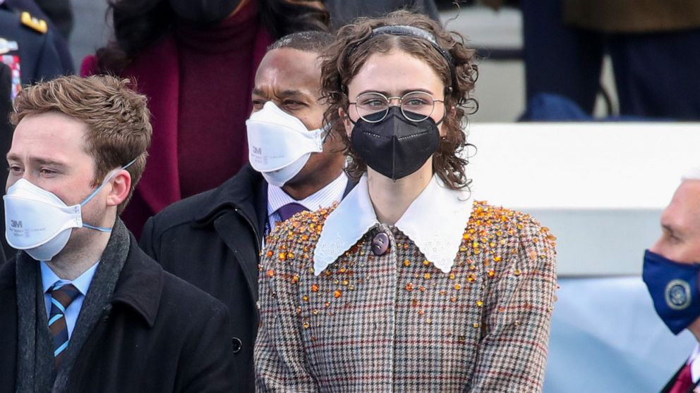 PHOTO: Cole Emhoff, left, and Ella Emhoff, center stand as Lady Gaga sings the National Anthem at the presidential inauguration of Joe Biden on the West Front of the U.S. Capitol on Jan. 20, 2021, in Washington.