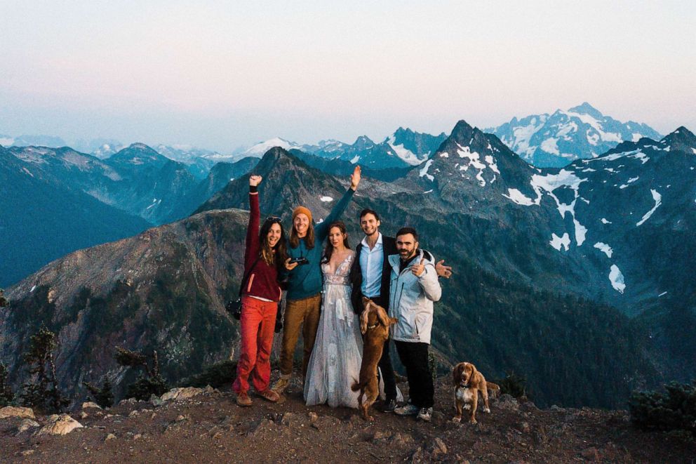 PHOTO: Brandon and Gabi Fox, far left, celebrate a successful adventure elopement.