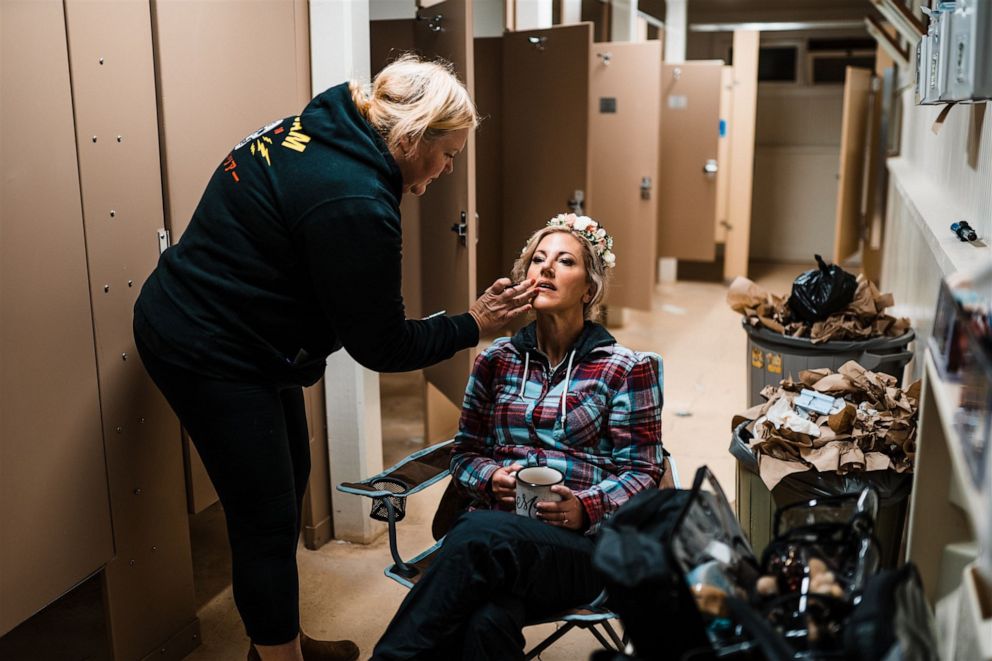 PHOTO: A bride gets her makeup done by makeup artist Anne Timss in a forest service restroom.