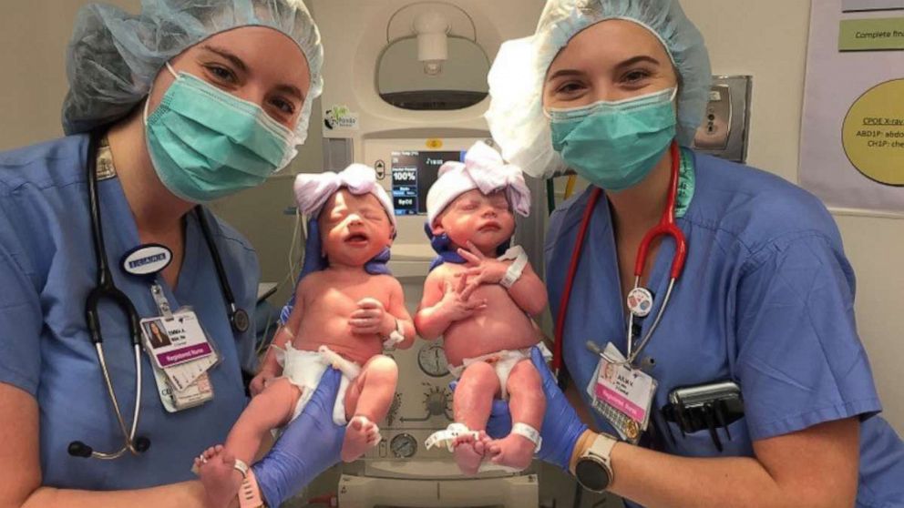 PHOTO: Nurses Emma Anderson and Julia Van Marter hold twins Emma and Julia Meehan. The nurses cared for the twins at HCA Healthcare's Rose Medical Center in Denver.