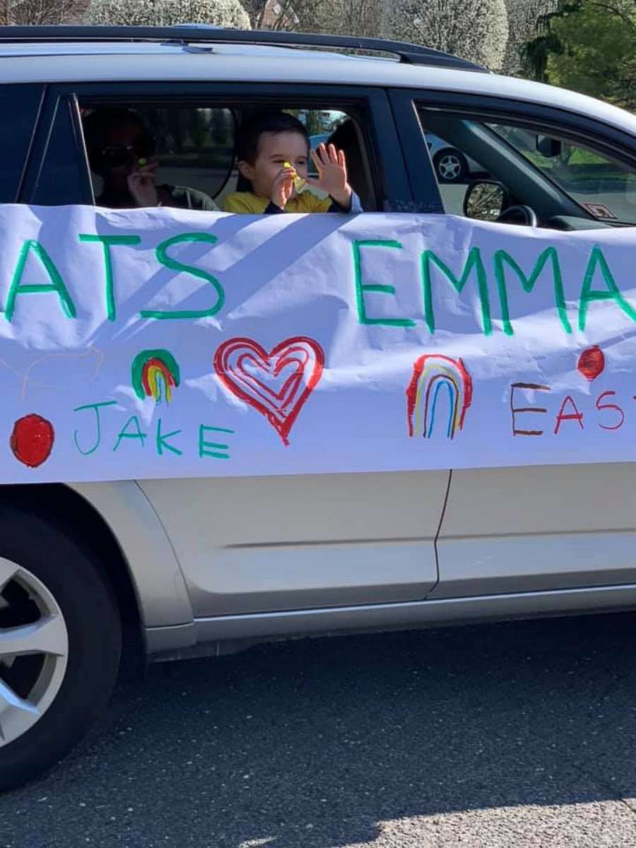 PHOTO: A young boy waves from a car in a parade to celebrate Emelina "Emma" Sergentakis' last day of chemotherapy on March 26, 2020, in Manalapan, N.J.