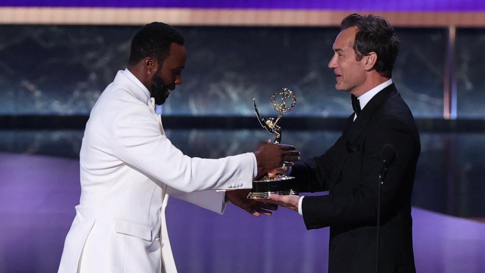 PHOTO: Tramell Tillman accepts the award for Outstanding Supporting Actor in a Drama Series for "Severance" from British actor Jude Law during the 77th Primetime Emmy Awards, in Los Angeles, September 14, 2025. 