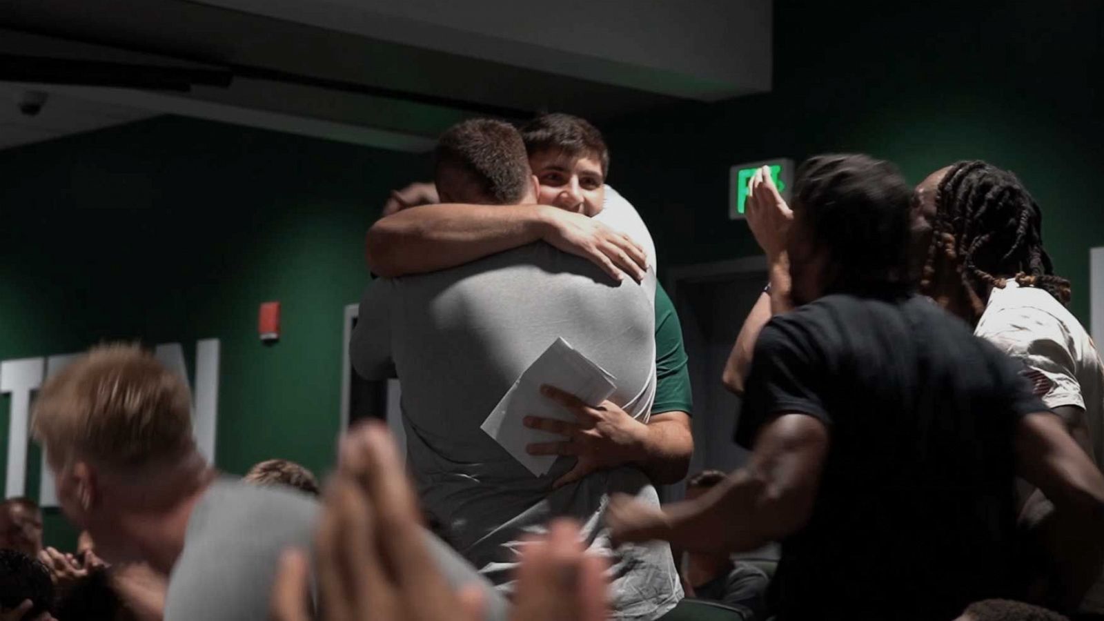 PHOTO: Zack Conti and Brian Dooley, Eastern Michigan University football players, embrace after Dooley gave Conti his football scholarship.