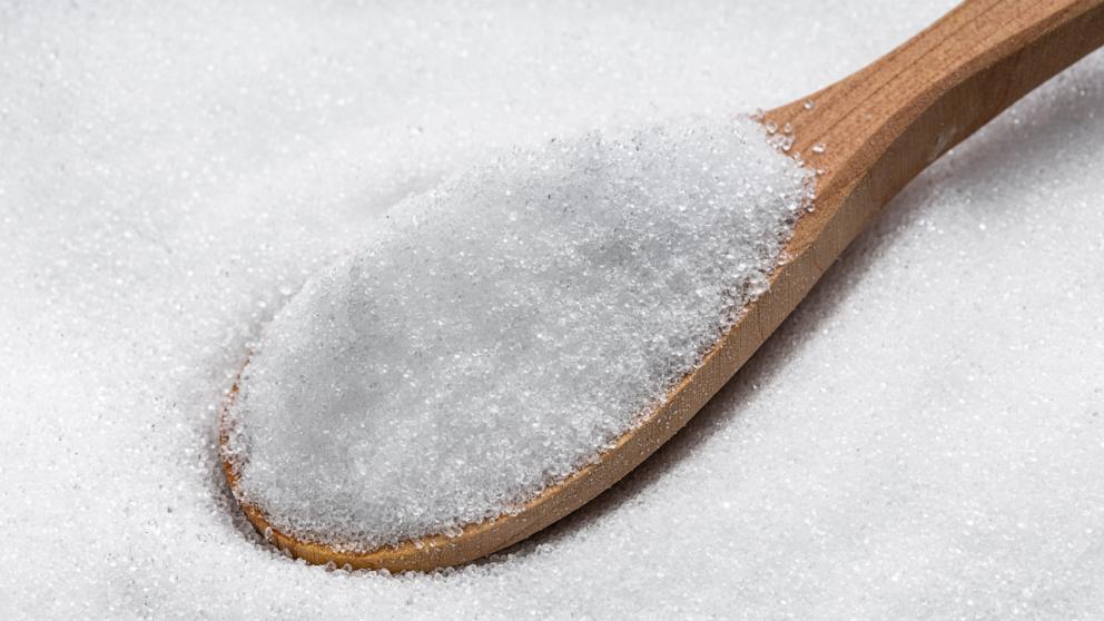 PHOTO: View of wooden spoon with crystalline erythritol, a sugar substitute.