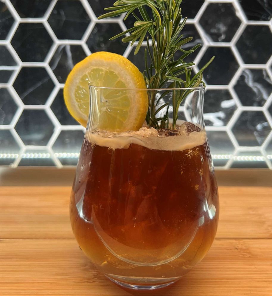PHOTO: An espresso tonic garnished with lemon and rosemary.