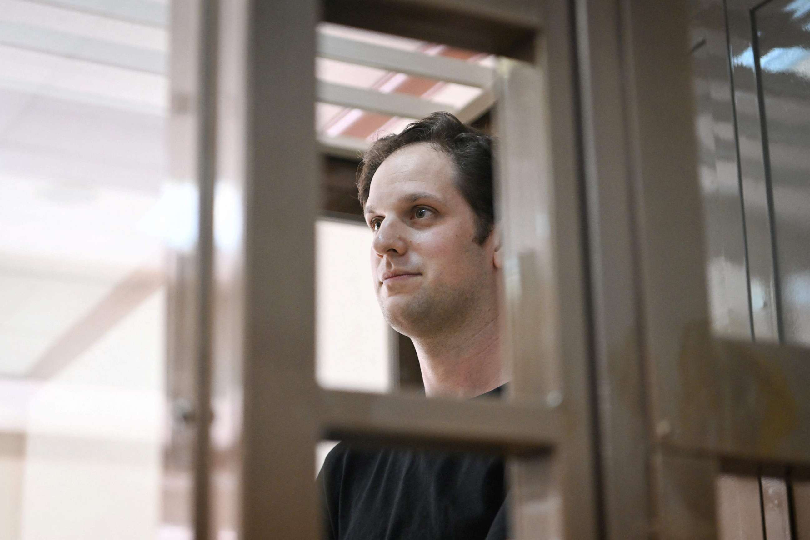 PHOTO: US journalist Evan Gershkovich, arrested on espionage charges, stands inside a defendants' cage before a hearing to consider an appeal on his extended detention at The Moscow City Court in Moscow on June 22, 2023.