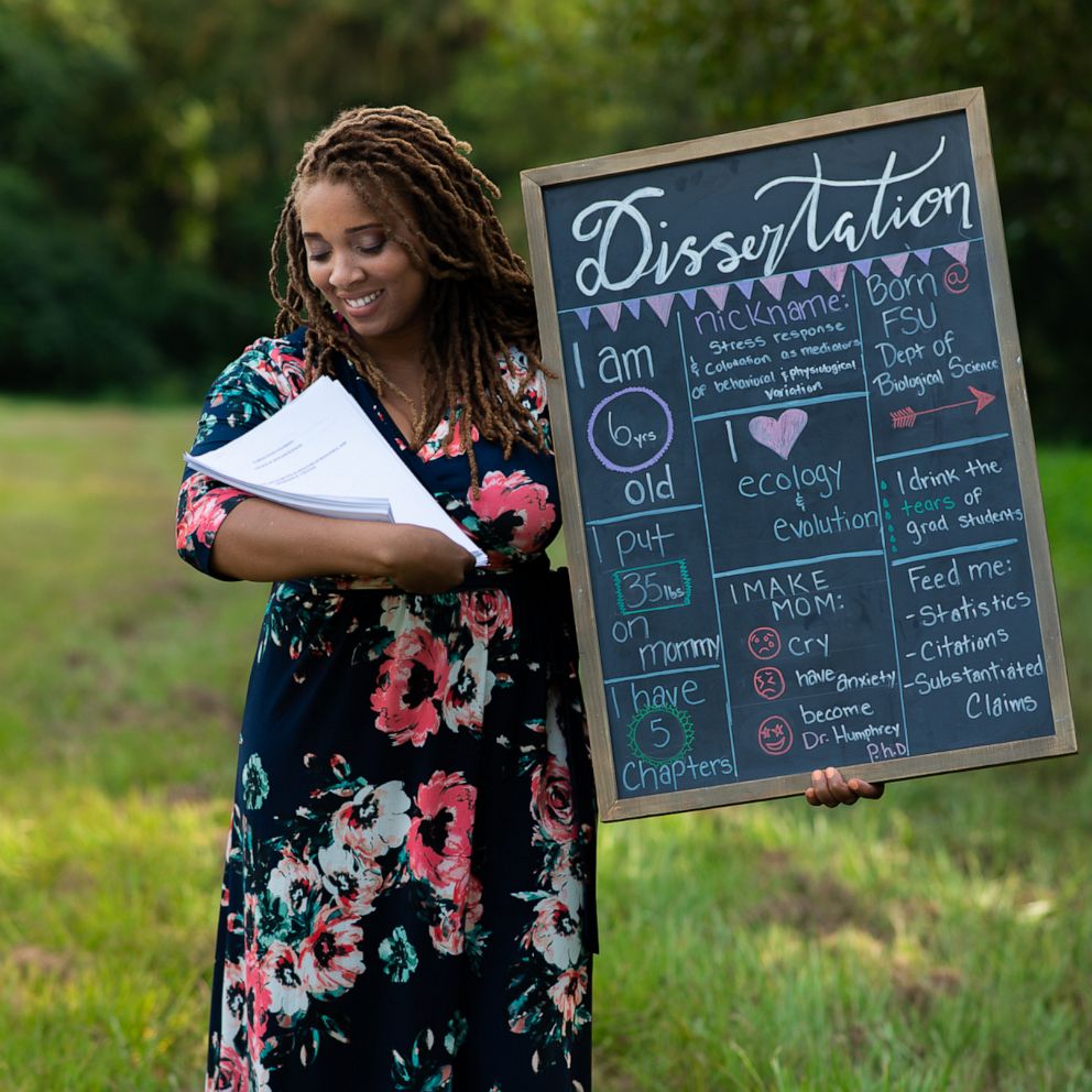 VIDEO: Woman poses with dissertation in newborn photoshoot spoof