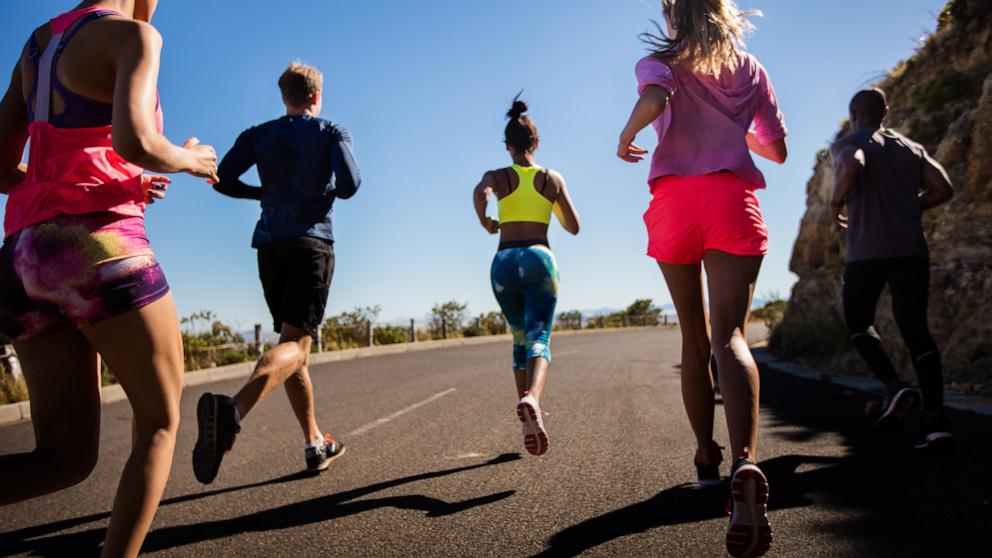 PHOTO: In this undated stock photo, a group of people are seen jogging together along a road. 