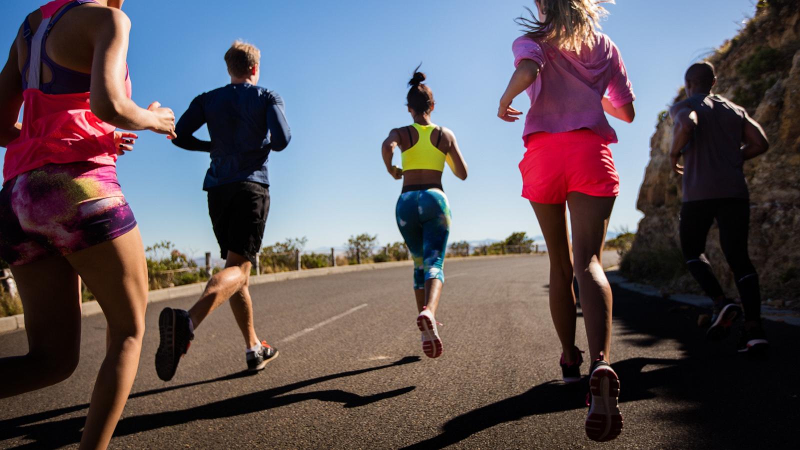 PHOTO: In this undated stock photo, a group of people are seen jogging together along a road.