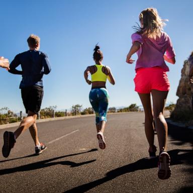 PHOTO: In this undated stock photo, a group of people are seen jogging together along a road. 