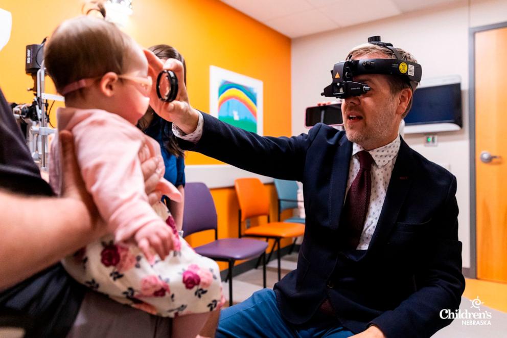 PHOTO: Dr. Paul Rychwalski, chief of ophthalmology at Children's Nebraska, does an eye exam on Madison Artale.