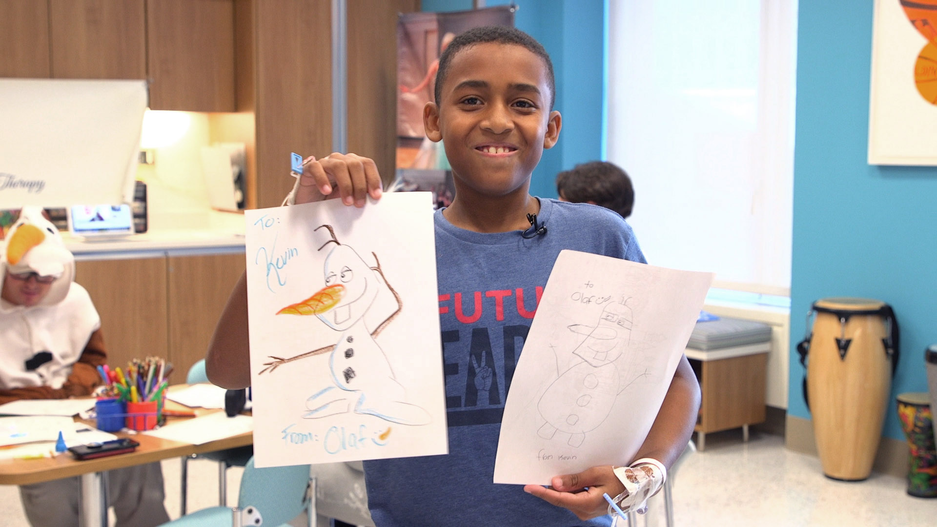 PHOTO: Kevin Joseph, a patient at New York Presbyterian Hospital shows off his portrait drawn by Olaf.