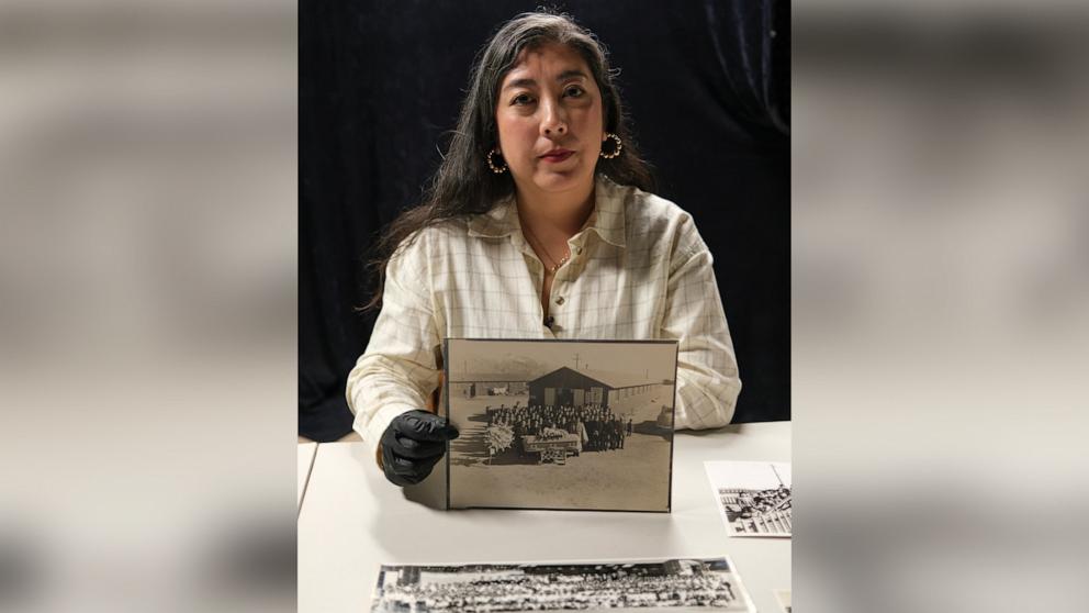 PHOTO: Caitlin Oiye Coon holds a family photo which she believes is of her grandmother’s sister’s funeral, who died in the Manzanar War Relocation Center.