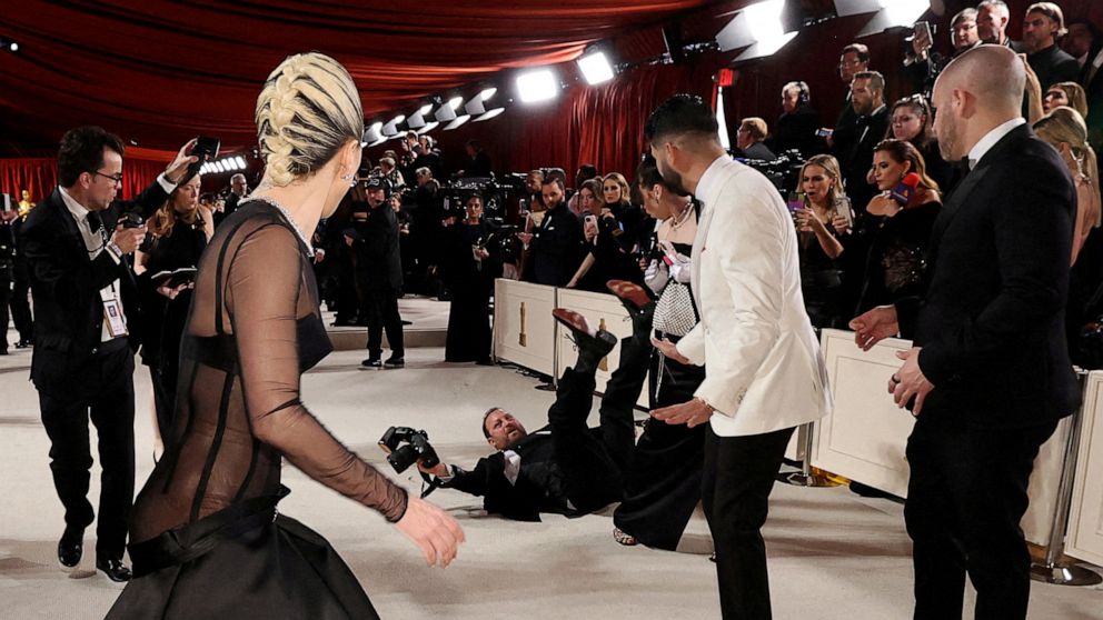 PHOTO: Lady Gaga reacts as a photographer falls on the champagne-colored red carpet during the Oscars arrivals at the 95th Academy Awards in Hollywood, Los Angeles, March 12, 2023.