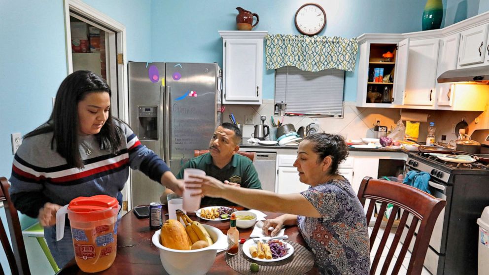 PHOTO: After work, nurse Flor Trevino eats dinner with husband Jose Trevino and daughter Stacy Trevino, in Houston, Dec. 7, 2020.