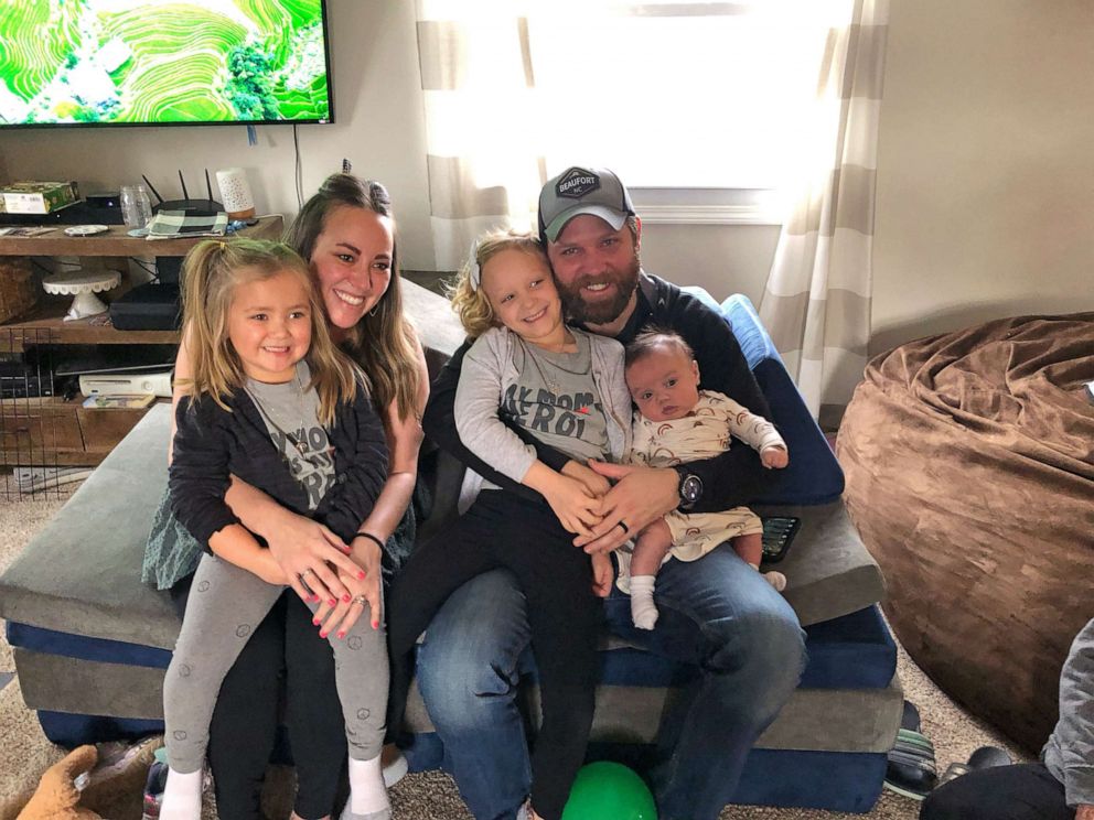PHOTO: Zach and Autumn Carver, of Indiana, pose with their three children after Autumn returned home from a 100-day hospitalization due to COVID-19.