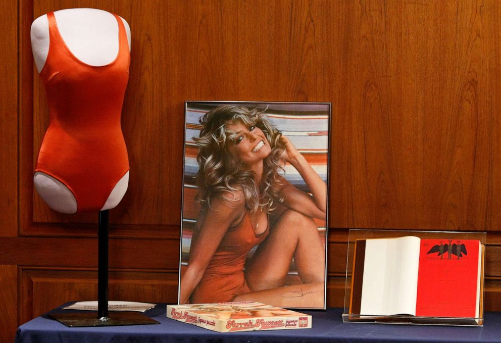 PHOTO: Farah Fawcett memorobilia including a red bathing suit, poster, and Charie's Angels script is seen at the Farrah Fawcett Memorabilia Donation at the Smithsonian National Museum of American History, Feb. 2, 2011, in Washington, DC.