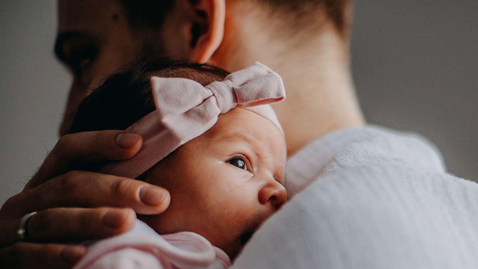 PHOTO: An undated stock photo depicts a man holding a newborn infant.r