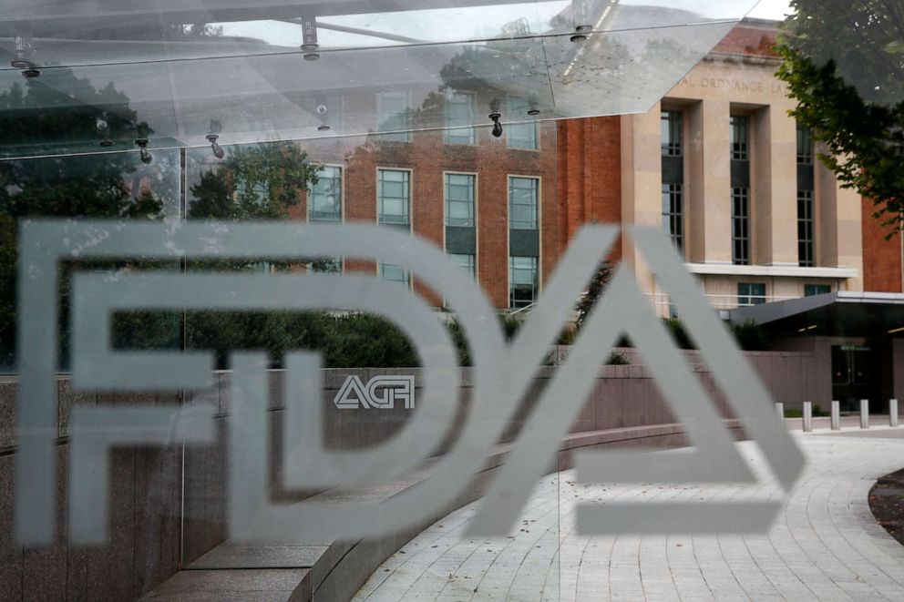 PHOTO: U.S. Food and Drug Administration building behind FDA logos at a bus stop on the agency's campus in Silver Spring, Md.