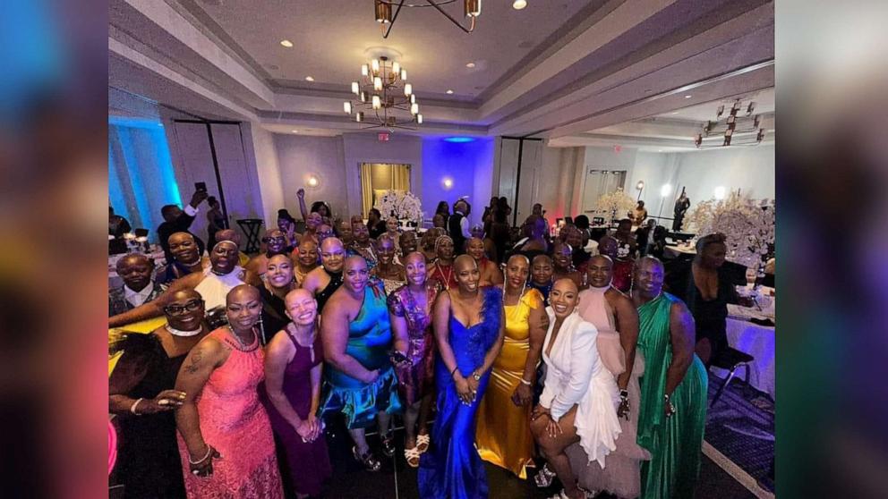 PHOTO: Felicia Flores, third from right, poses with attendees at the Baldie Con conference she founded.