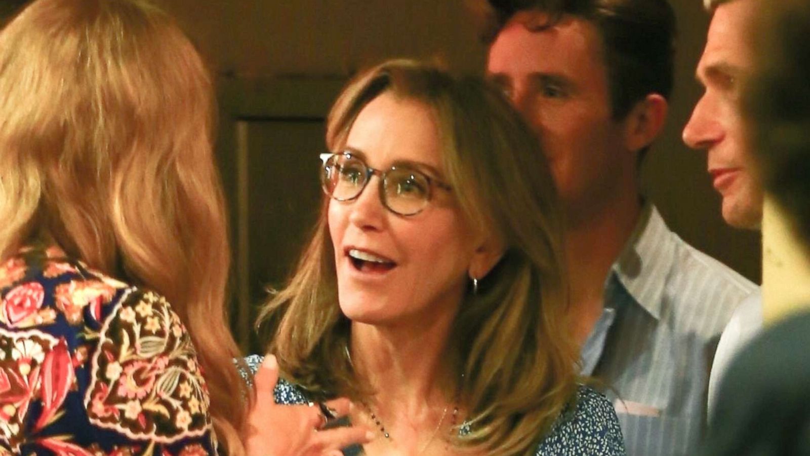 PHOTO: Felicity Huffman chats with friends and family after attending her daughter Sofia Grace's high school graduation ceremony in Hollywood, Calif., June 10, 2019.