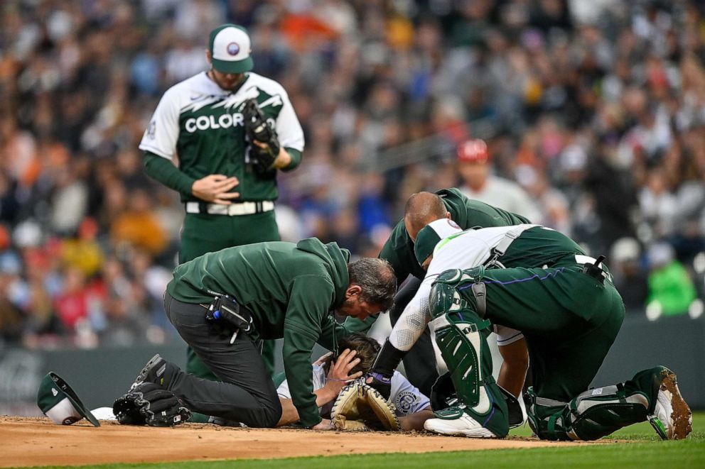 PHOTO: Ryan Feltner lies on the mound and is tended to by Elias Diaz #35 and Colorado Rockies training staff after being hit by a comebacker in the second inning of a game against the Philadelphia Phillies at Coors Field on May 13, 2023 in Denver.