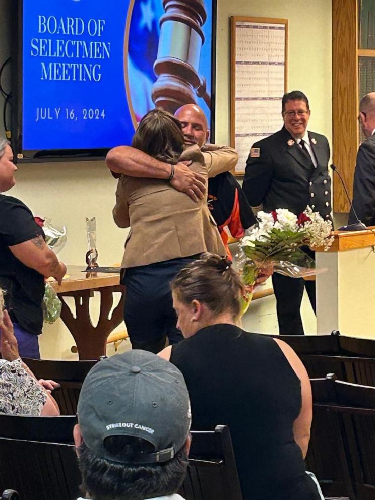 PHOTO: Phil Davis, president of the Oxford Little League, hugs Dr. Jennifer LaFemina after they were both honored for their lifesaving efforts.