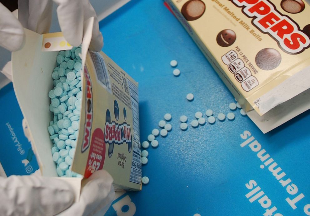 PHOTO: Los Angeles County Sheriff's Narcotics Bureau detectives display some of the approximately 12,000 suspected fentanyl pills hidden inside candy boxes, seized at Los Angeles International Airport, Oct. 19, 2022.