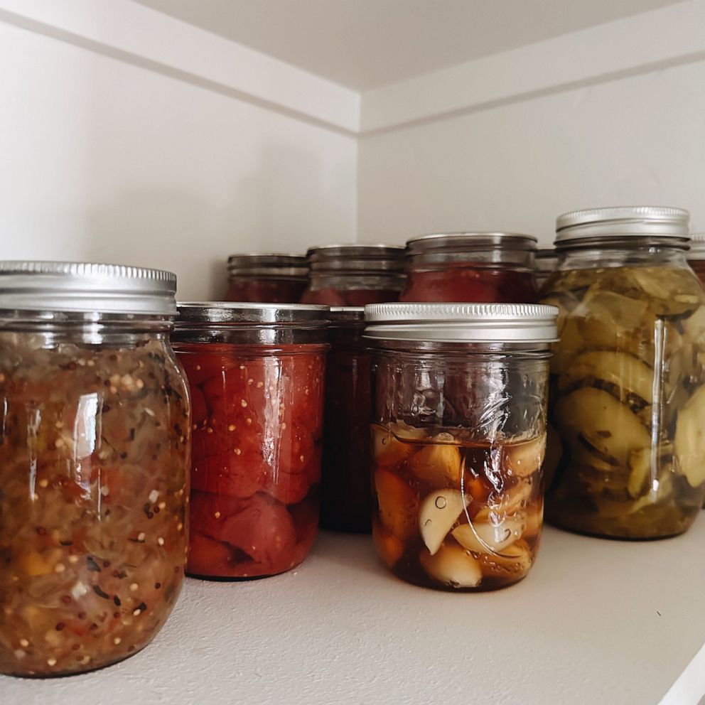 PHOTO: A jar of fermented garlic honey on a pantry shelf.