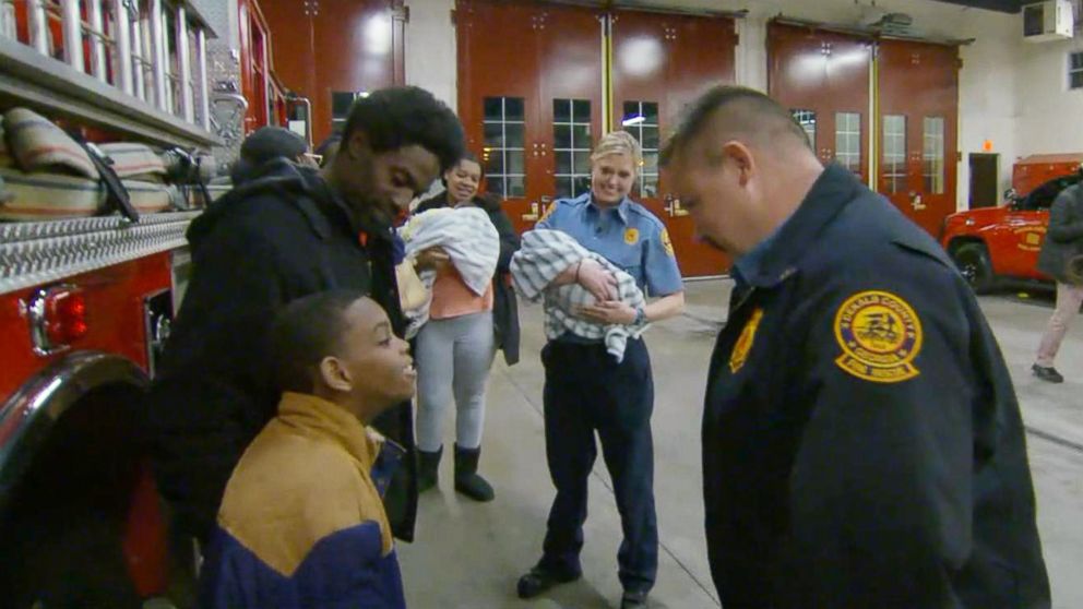 PHOTO: Captain Scott Stroup of the Dekalb County Fire Rescue Department meets with the family who he helped save from a burning apartment building.