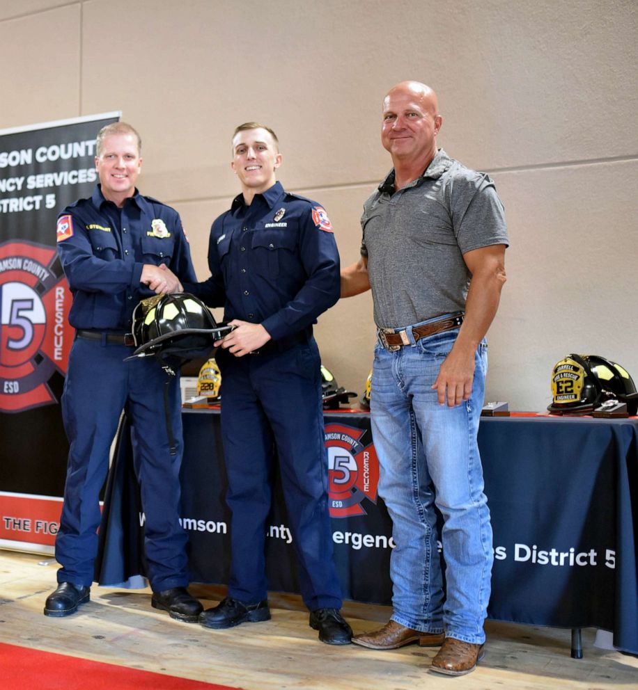 PHOTO: Jake Owen, center, is pictured alongside his dad, Craig Owen, far right, at his promotion ceremony in 2022.