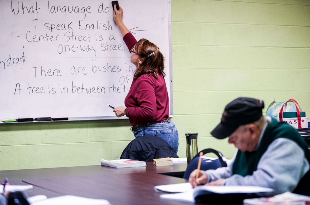 PHOTO: Instuctor Tricia Santana erases the previous lesson from the board as a student studies at the Adult Literacy Council of the Concho Valley in San Angelo, Texas  Nov. 1, 2018.