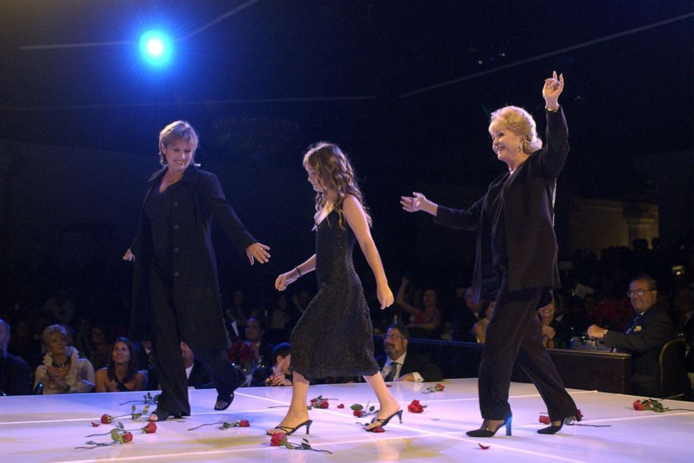 PHOTO: Carrie Fischer with her daughter and mother, Debbie Reynolds, walks on stage during the 2nd Annual "Runway for Life" celebrity fashion show benefiting St. Jude Children's Research Hospital, Aug. 19, 2003, in Beverly Hills, Calif.
