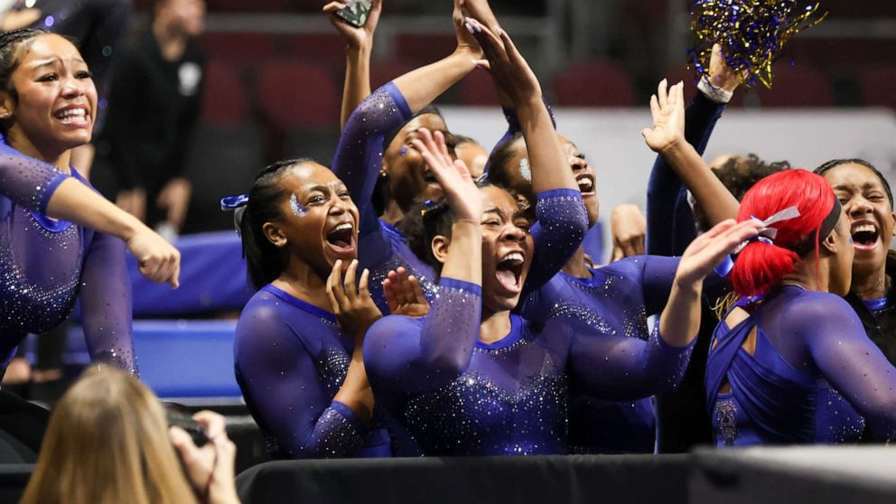 PHOTO: Members of the Fisk University team cheer during a Super 16 gymnastics meet, Jan. 6, 2023, in Las Vegas.