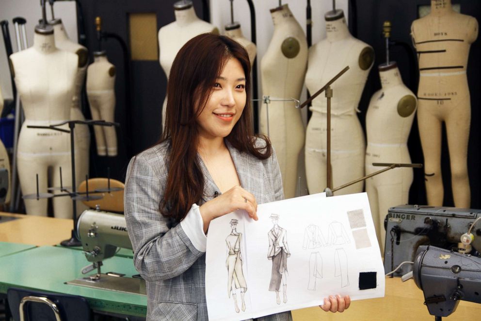 PHOTO: Sooyoung Yun, FIT student, displays design sketches for Mary Poppins inspired garments.