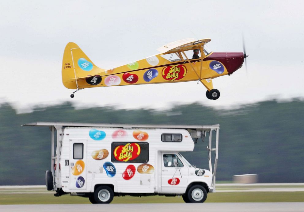 PHOTO: An Interstate Cadet promotional plane takes off from the the top of a Jelly Belly vehicle during a stunt during the Gulf Coast Salute Airshow,   in Panama City, Fla., April 11, 2015.