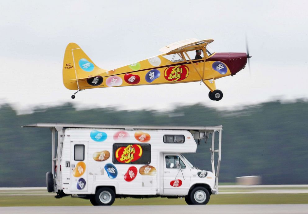 PHOTO: An Interstate Cadet promotional plane takes off from the the top of a Jelly Belly vehicle during a stunt during the Gulf Coast Salute Airshow, in Panama City, Fla., April 11, 2015.