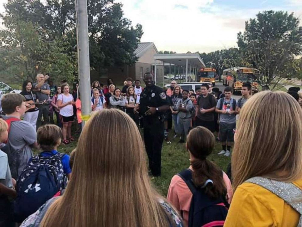 PHOTO: Officer DeAndra Warren stands at the flagpole with Wynne Public School students in Wynne, Ark.