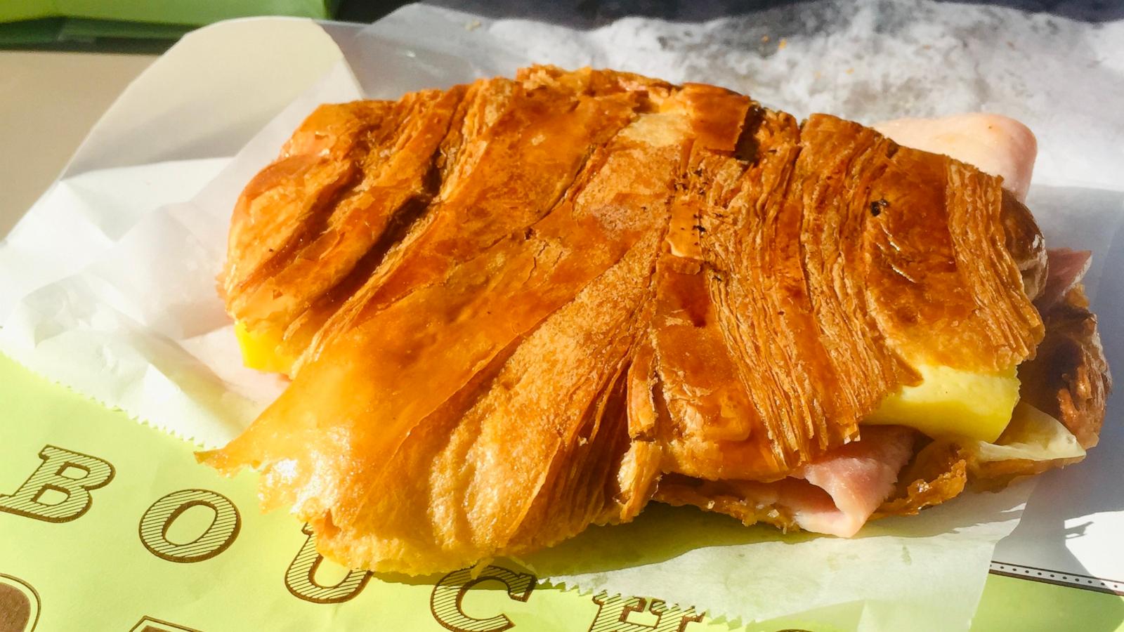 PHOTO: A pressed croissant sandwich with crispy exterior.