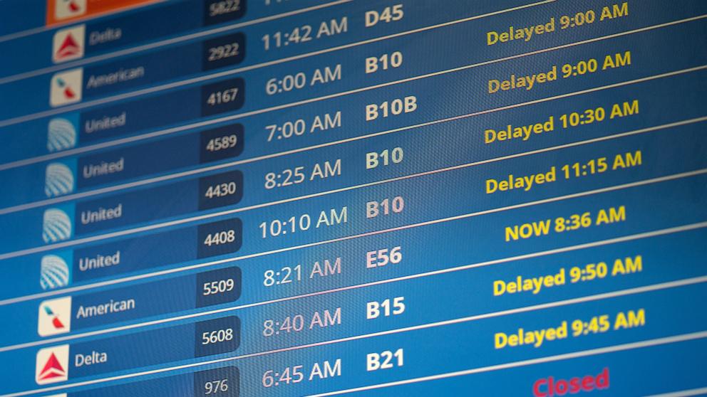 PHOTO: In this July 19, 2024, file photo, flight information is seen on a display screen at Ronald Regan Washington National Airport in Washington, D.C.