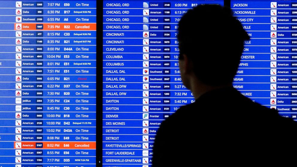 PHOTO: A flight departure information board is seen, July 23, 2024 at Ronald Reagan Airport in Arlington, Virginia.