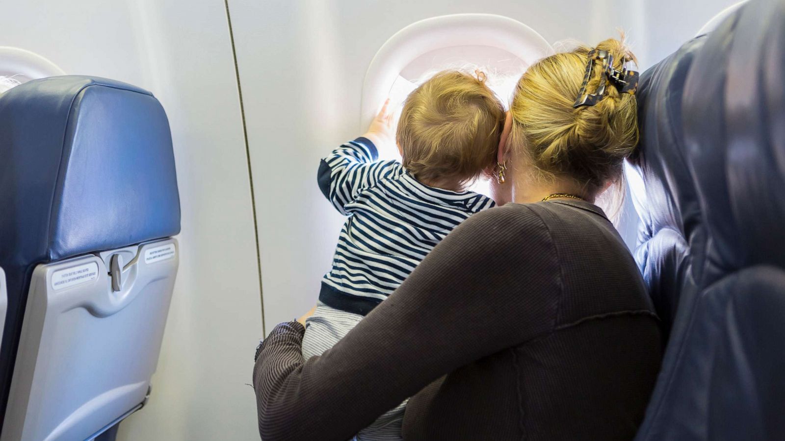 PHOTO: A mother and baby, mom, child airplane.