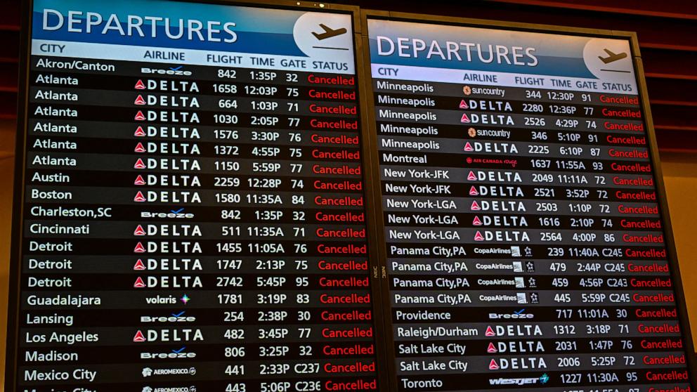 PHOTO: In this July 19, 2024, file photo, flight information is seen on a display screen at Ronald Regan Washington National Airport in Washington, D.C.