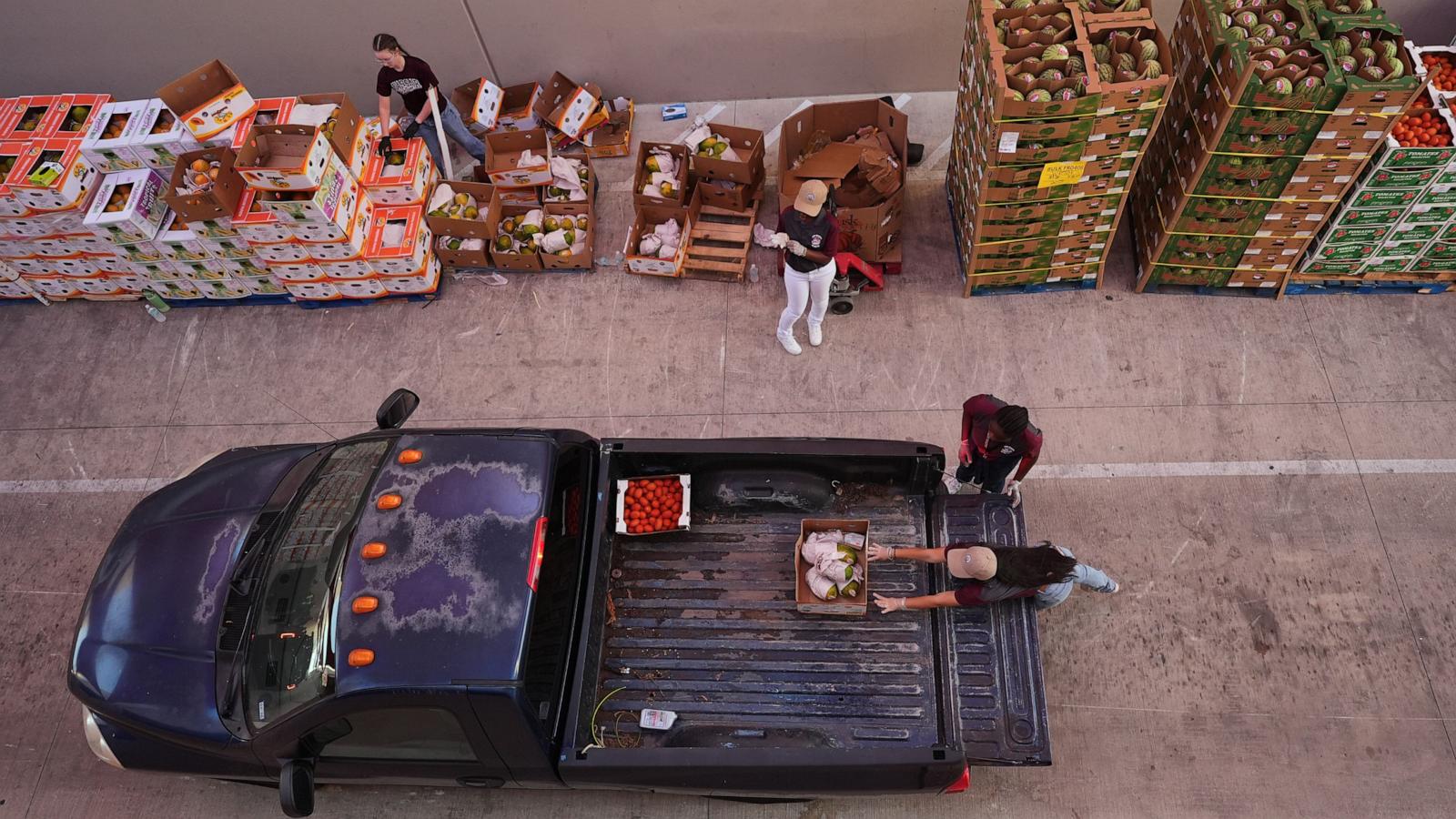 PHOTO: Volunteers help load vehicles during a food distribution at the San Antonio Food Bank for SNAP recipients, Nov. 6, 2025, in San Antonio.