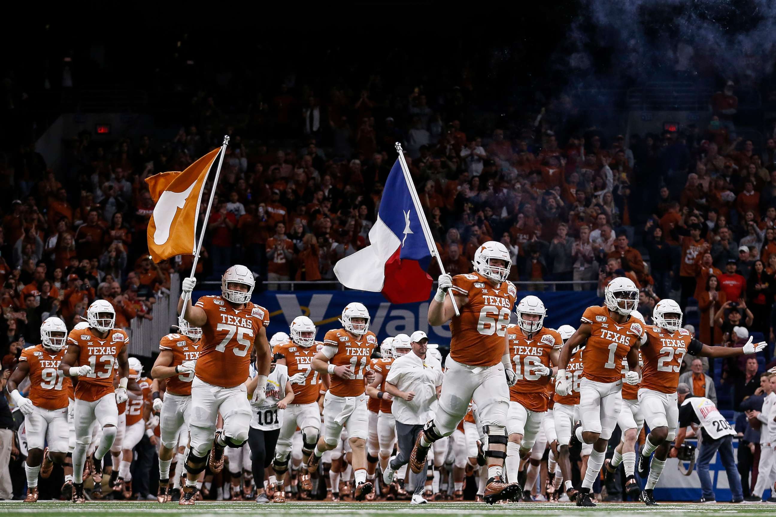 PHOTO: The Texas Longhorns take the field during the Valero Alamo Bowl against the Utah Utes at the Alamodome on December 31, 2019 in San Antonio, Texas.